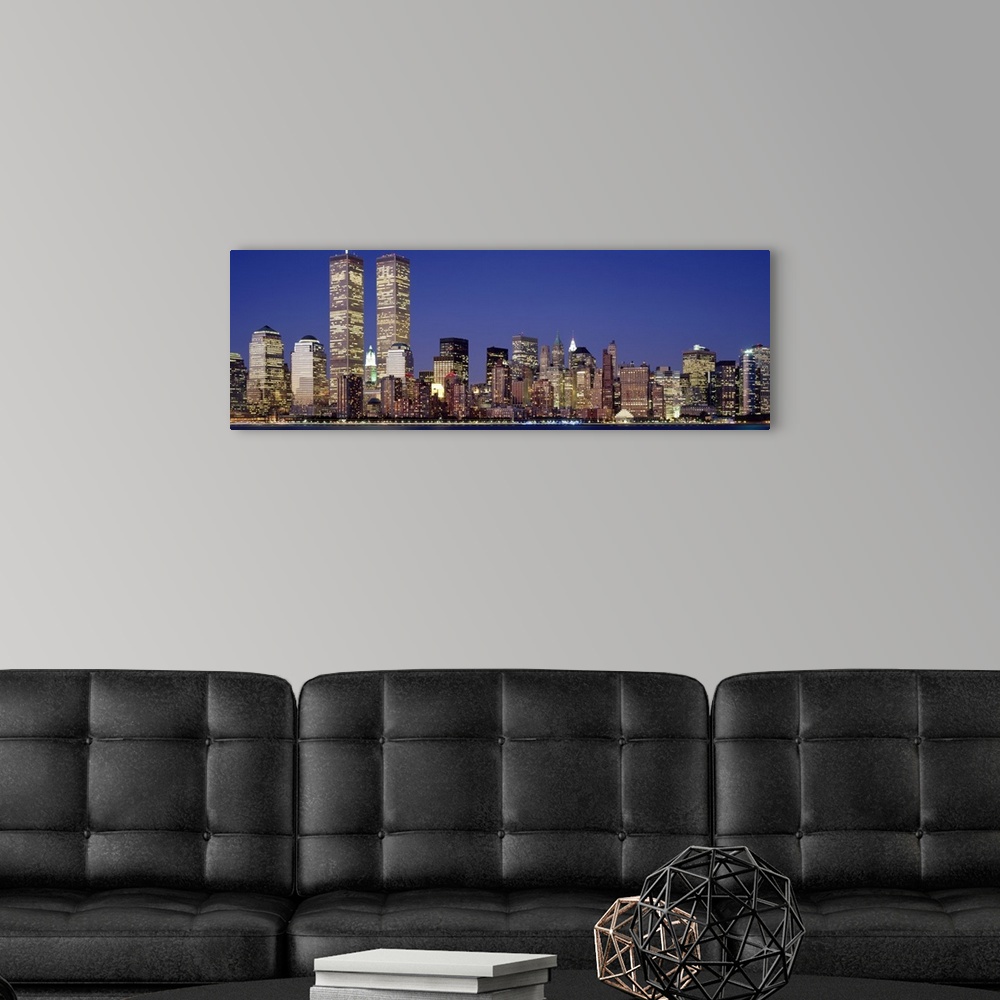 A modern room featuring Panoramic photograph displays the nighttime skyline of a busy city within the Northeastern United...