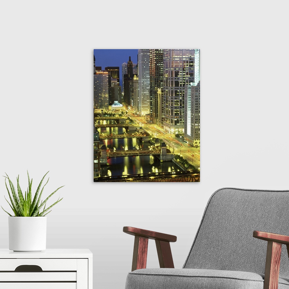A modern room featuring Big photograph shows an aerial view overlooking groups of skyscrapers found within a busy Midwest...
