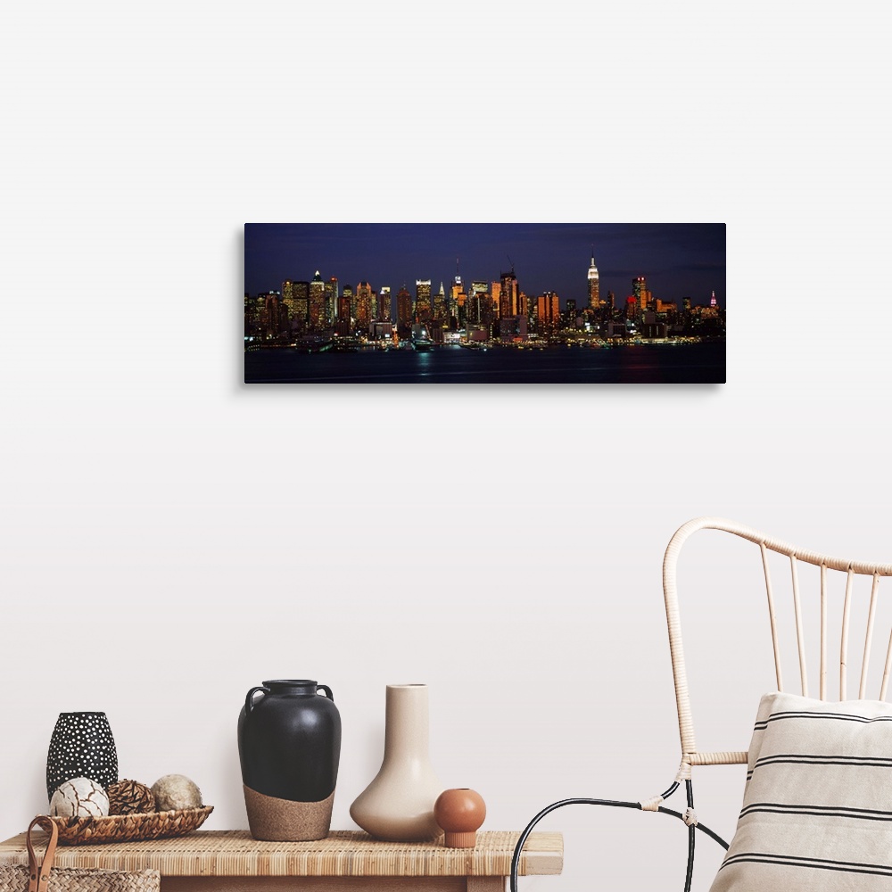 A farmhouse room featuring Panoramic photograph of skyscrapers filling the skyline of Manhattan in New York at night.  The b...