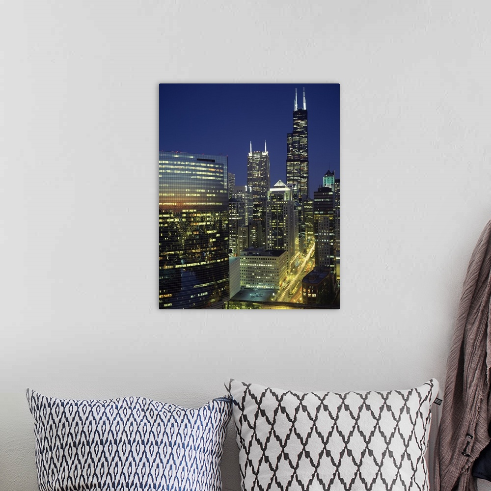 A bohemian room featuring Vertical, high angle photograph overlooking Wacker Drive in Chicago, surrounded by lit buildings ...