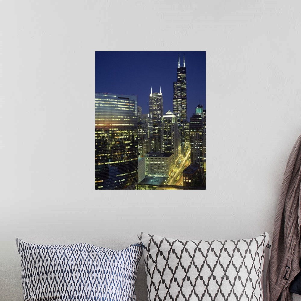 A bohemian room featuring Vertical, high angle photograph overlooking Wacker Drive in Chicago, surrounded by lit buildings ...