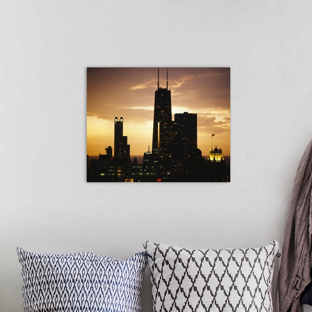 A bohemian room featuring Horizontal photograph on a big canvas of lit, tall buildings  of the Chicago skyline against the ...