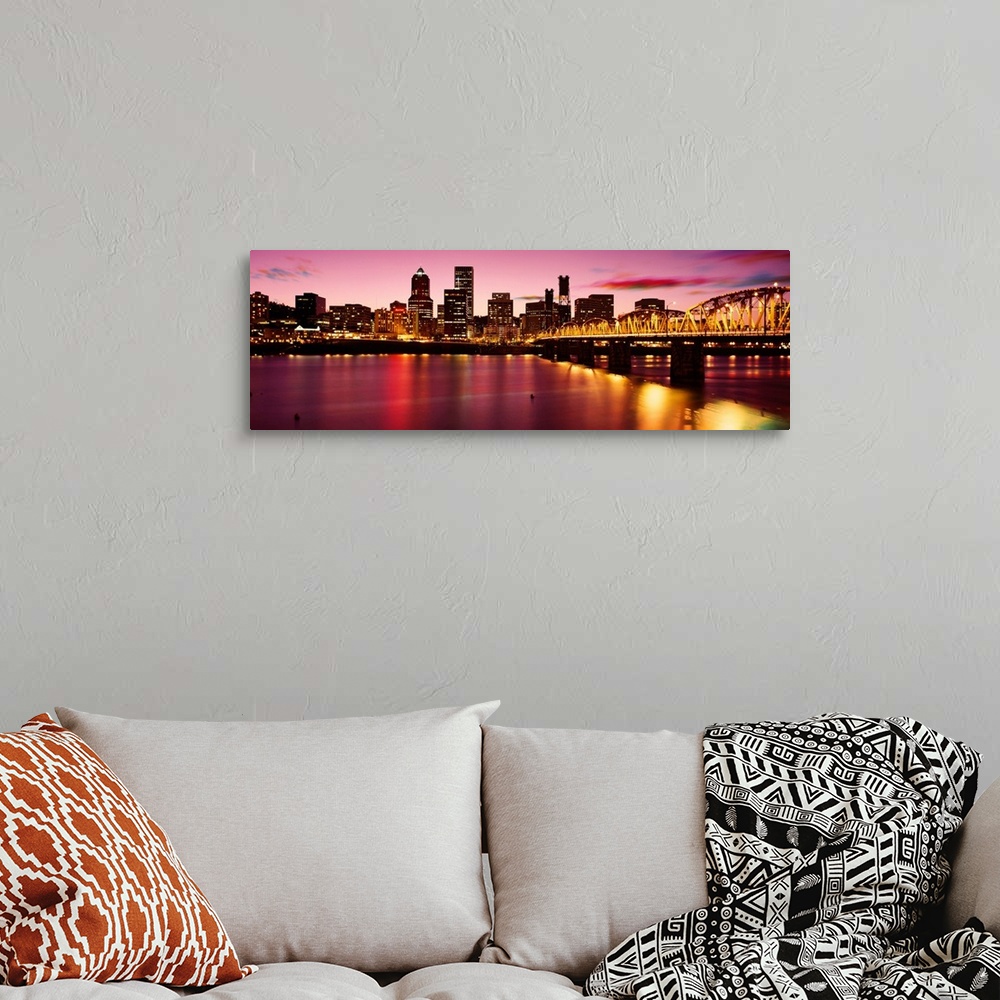 A bohemian room featuring A panoramic city scape photograph of the downtown area photograph from across the river.