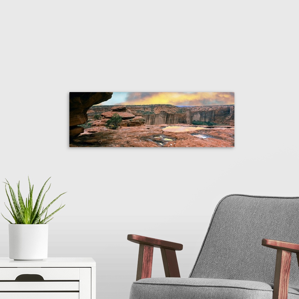 A modern room featuring Slickrock waterpocket pools reflect sunrise colors, Canyon De Chelly National Monument, Arizona, ...