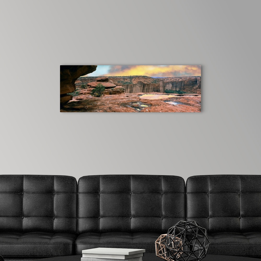 A modern room featuring Slickrock waterpocket pools reflect sunrise colors, Canyon De Chelly National Monument, Arizona, ...