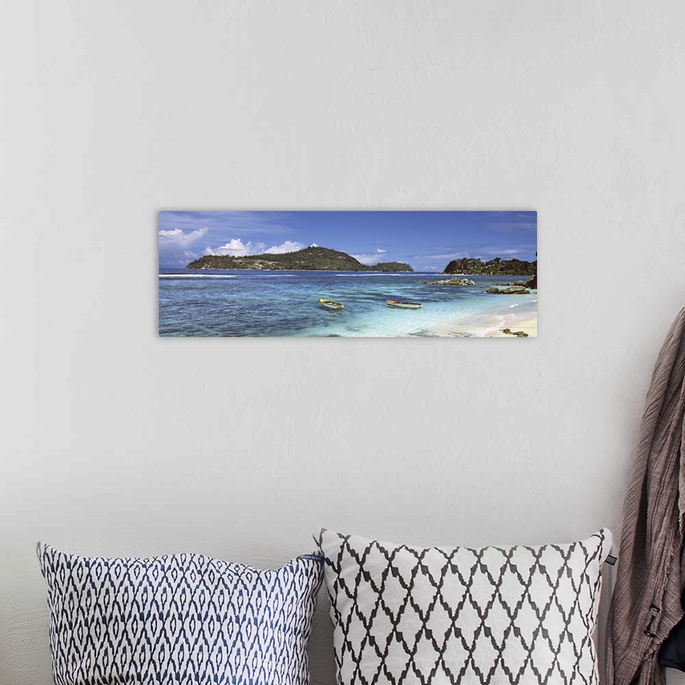 A bohemian room featuring Small fishing boats on Anse L'Islette with Therese Island in background, Seychelles