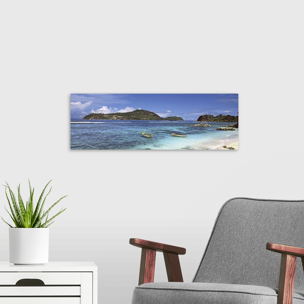 A modern room featuring Small fishing boats on Anse L'Islette with Therese Island in background, Seychelles
