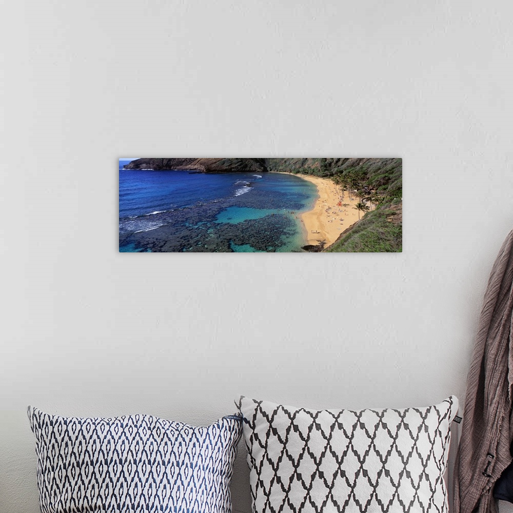 A bohemian room featuring Panoramic photograph of inlet with coral and beach lined with mountains.
