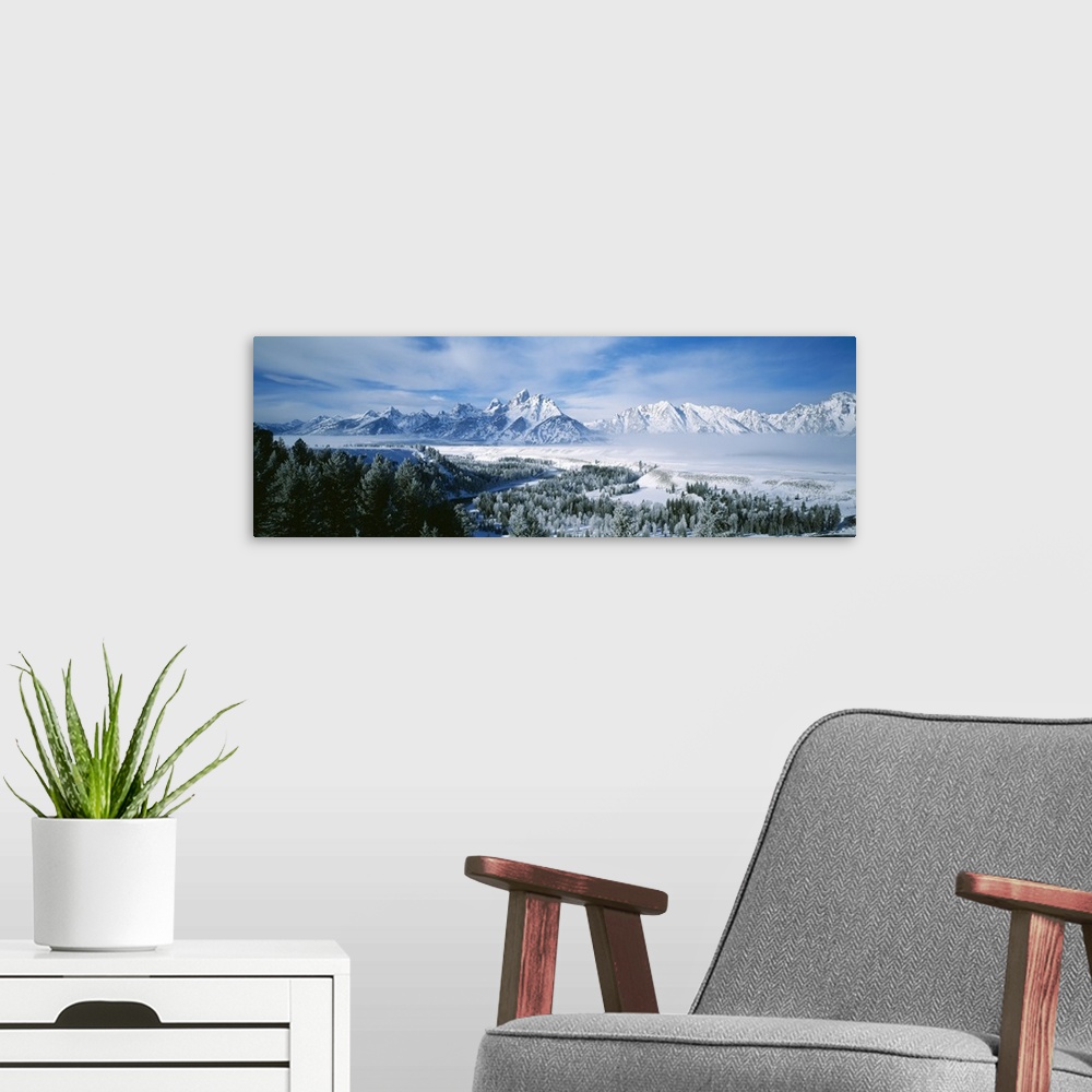 A modern room featuring This is a panoramic photograph of the snowscape surrounding these Montana mountain peaks in winter.