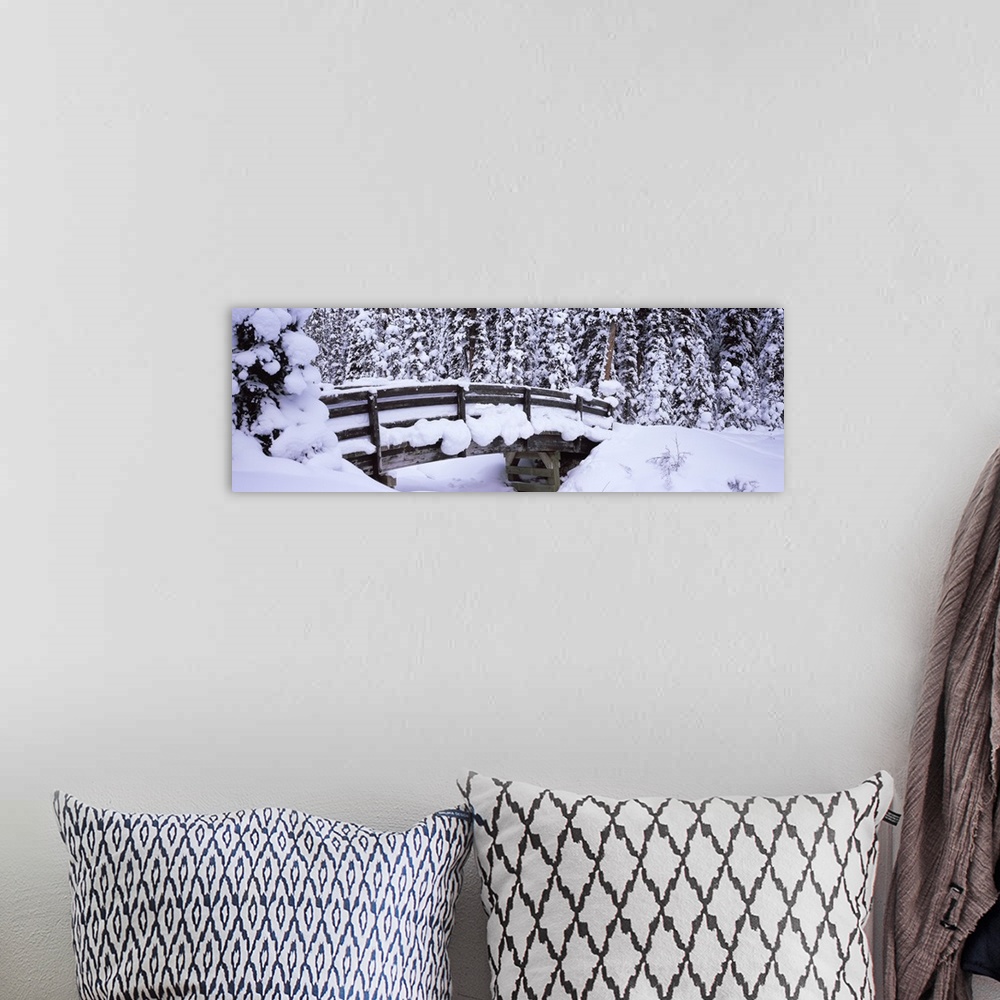 A bohemian room featuring Long horizontal photo on canvas of a heavily snow covered bridge in the middle of a forest.