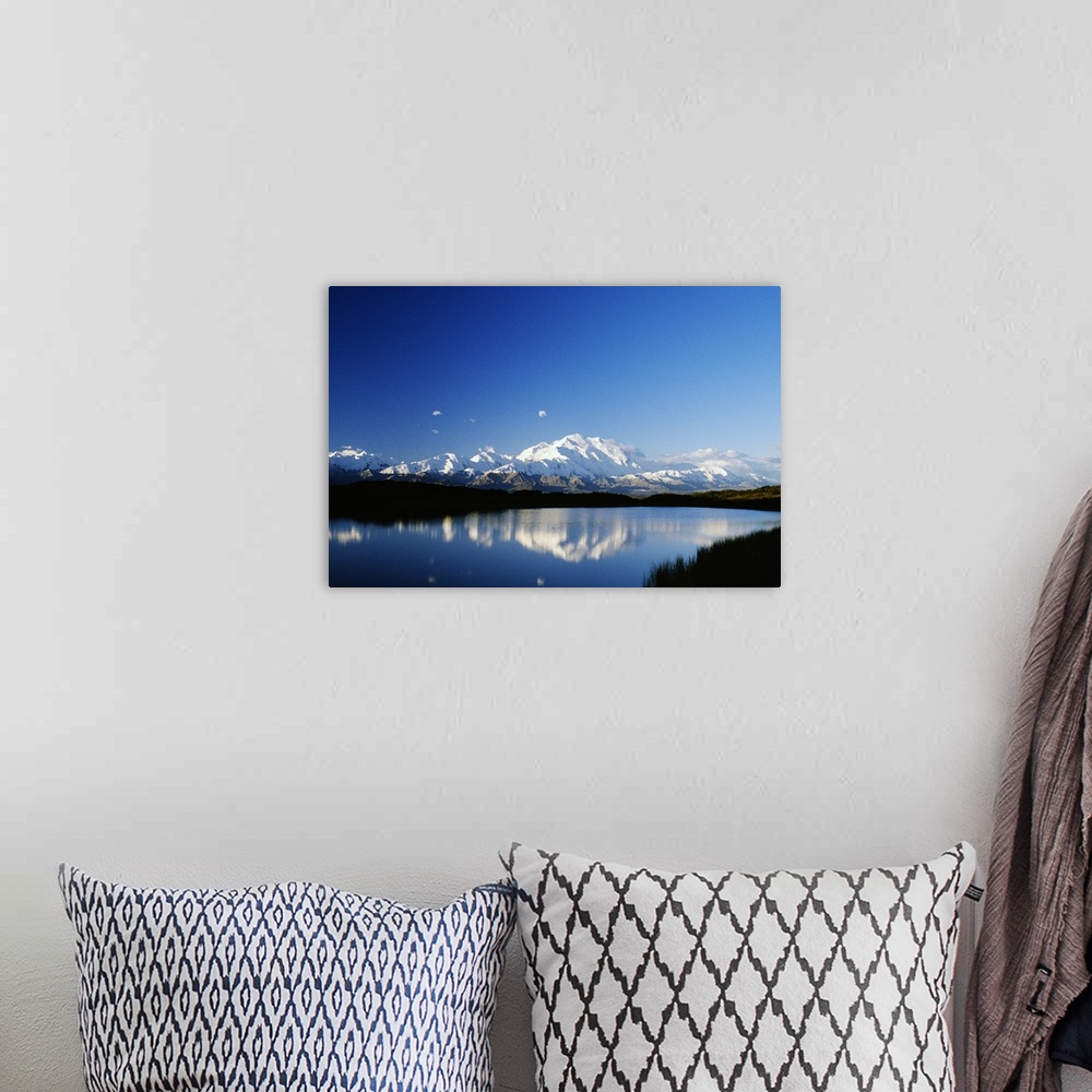 A bohemian room featuring Snow-covered Mount McKinley reflected in lake, blue sky, Denali National Park, Alaska