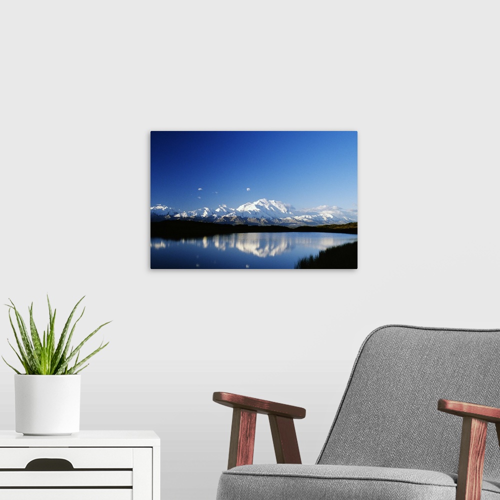 A modern room featuring Snow-covered Mount McKinley reflected in lake, blue sky, Denali National Park, Alaska