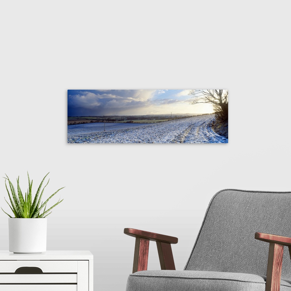 A modern room featuring Snow covered road passing through a landscaped, Bempton, East Riding of Yorkshire, England