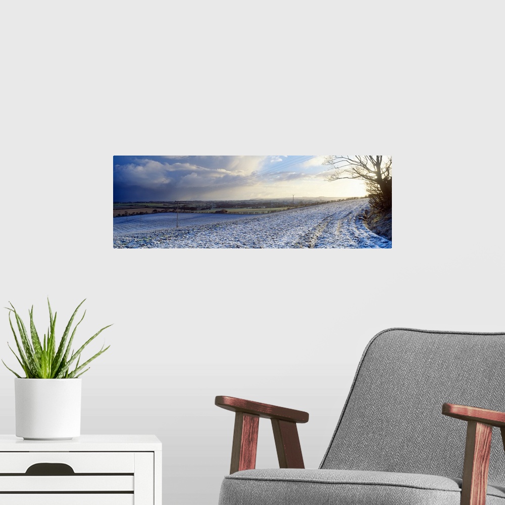 A modern room featuring Snow covered road passing through a landscaped, Bempton, East Riding of Yorkshire, England