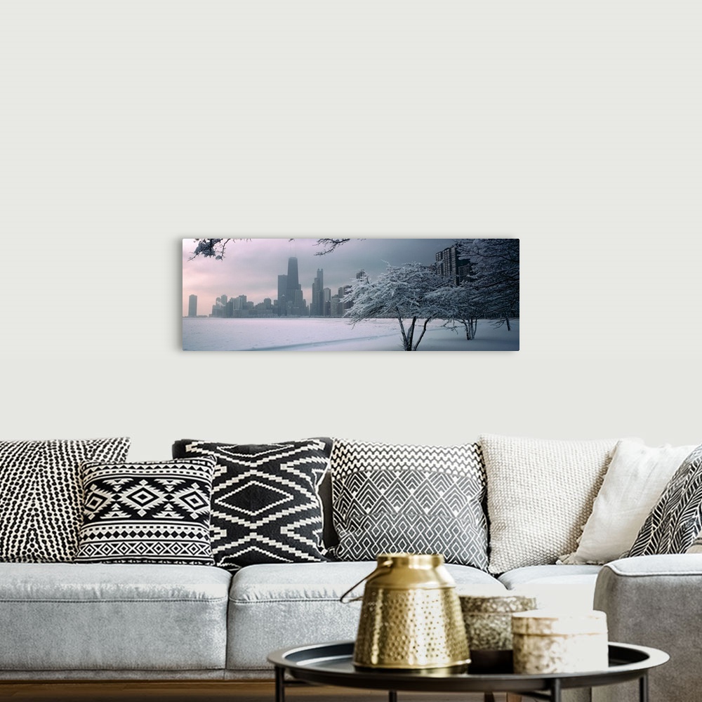 A bohemian room featuring Panoramic photograph of winter snow on a shore with a city skyline in the distance.  There are tr...