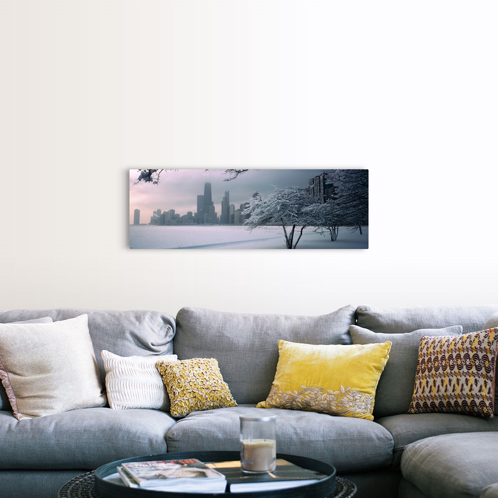 A farmhouse room featuring Panoramic photograph of winter snow on a shore with a city skyline in the distance.  There are tr...