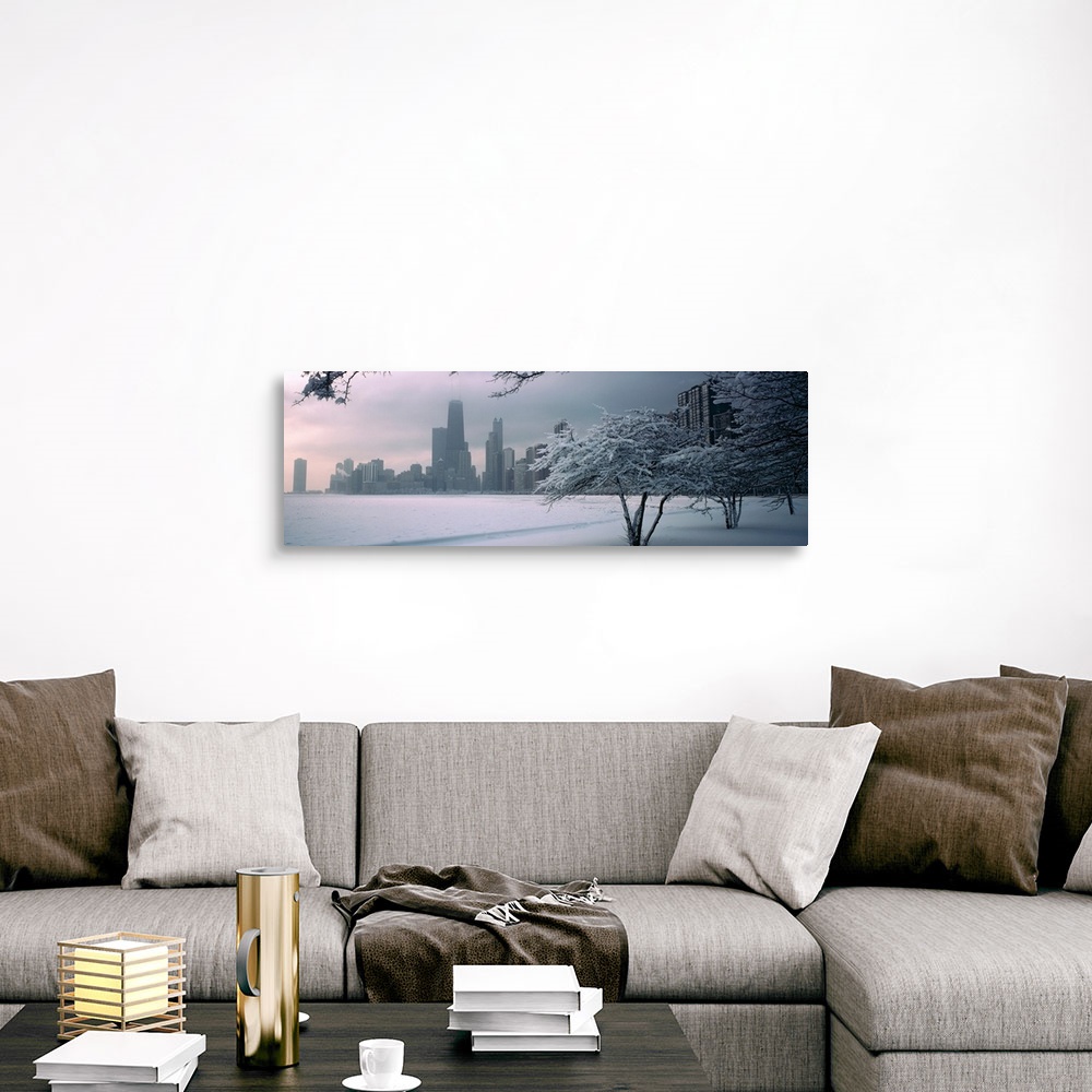 A traditional room featuring Panoramic photograph of winter snow on a shore with a city skyline in the distance.  There are tr...