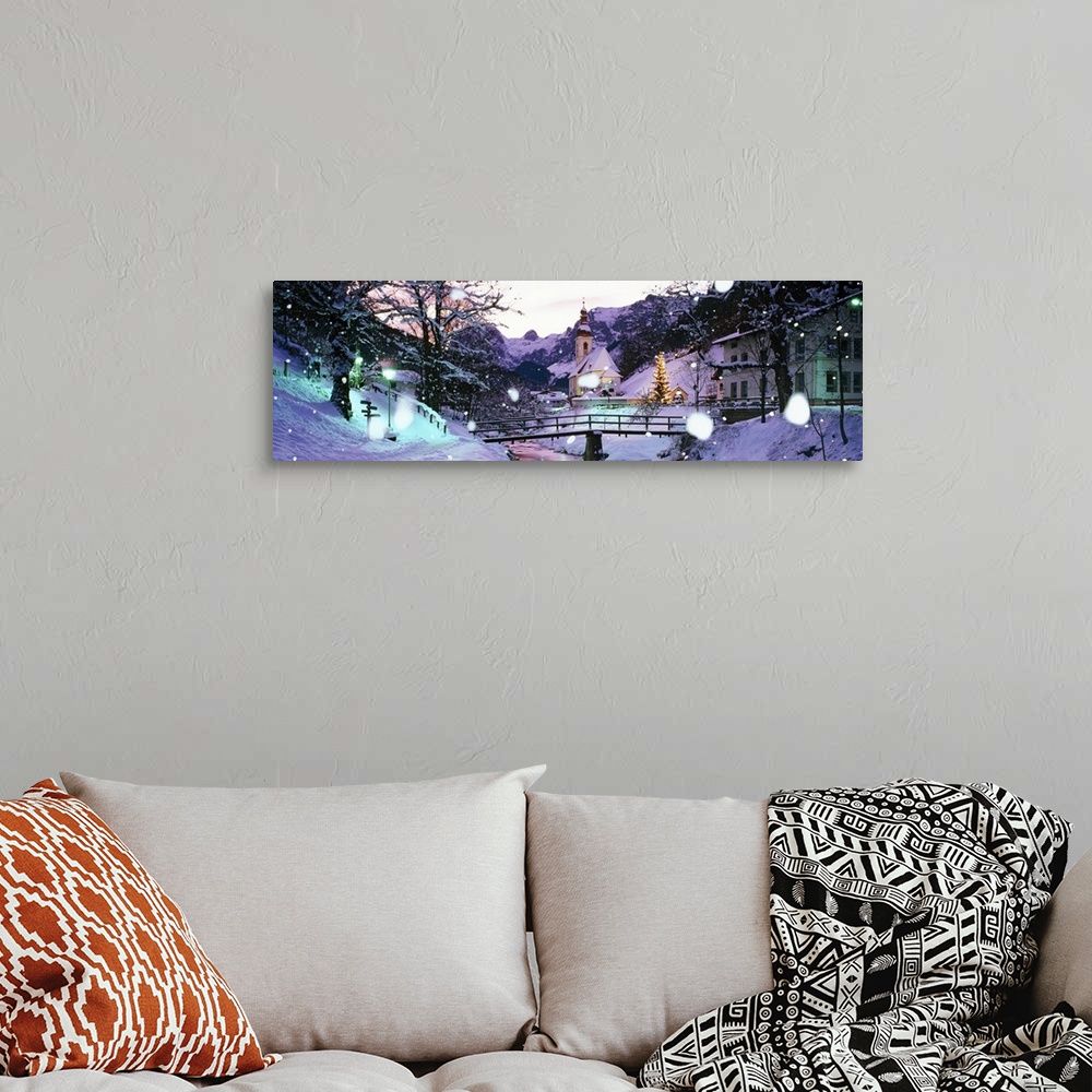 A bohemian room featuring Large panoramic photograph of snowing falling and covering a town with buildings to the right and...