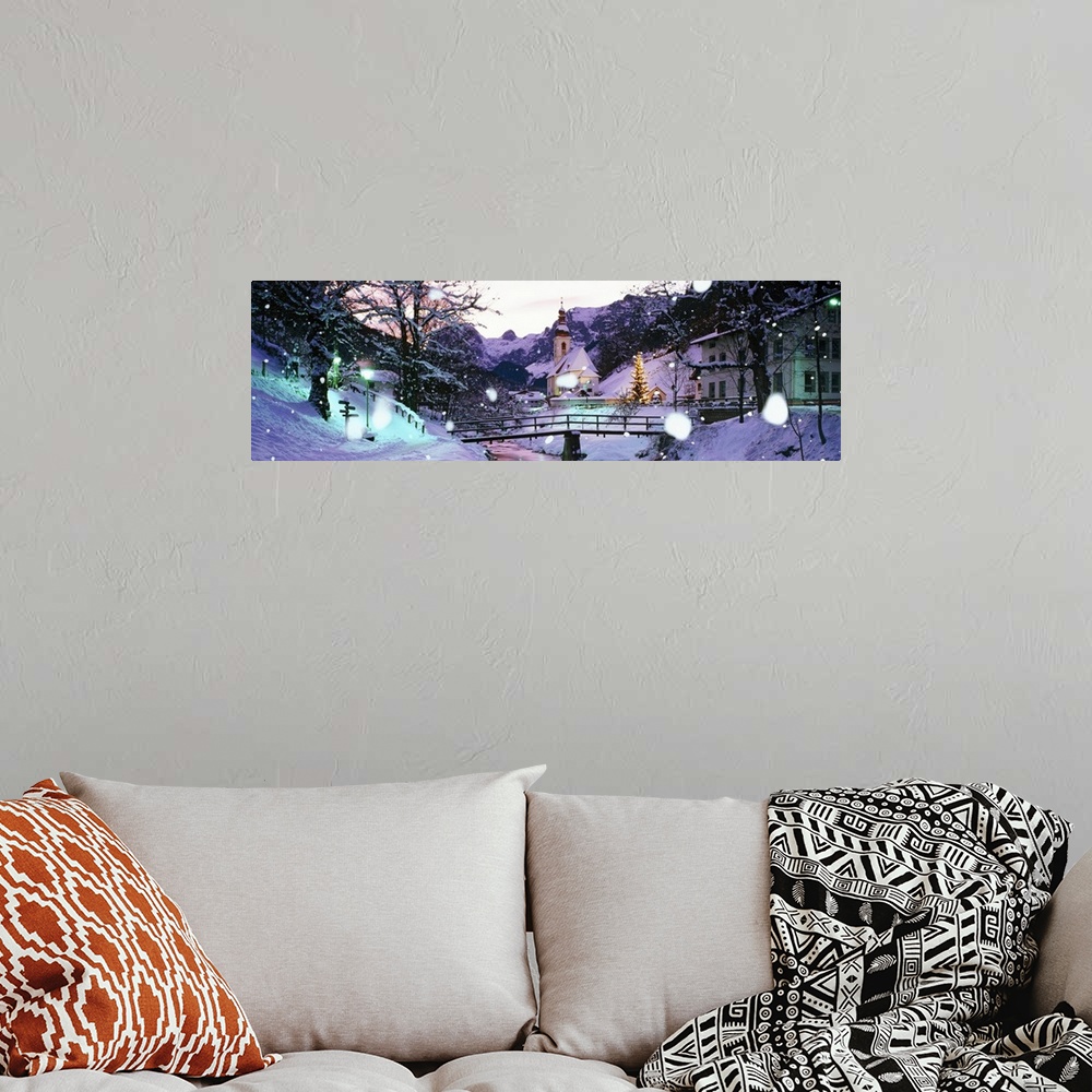 A bohemian room featuring Large panoramic photograph of snowing falling and covering a town with buildings to the right and...