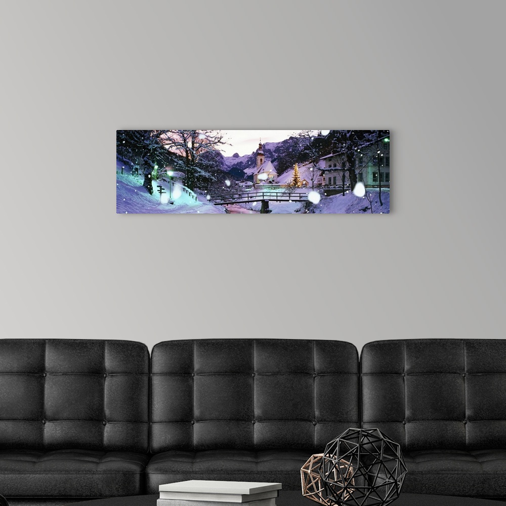 A modern room featuring Large panoramic photograph of snowing falling and covering a town with buildings to the right and...