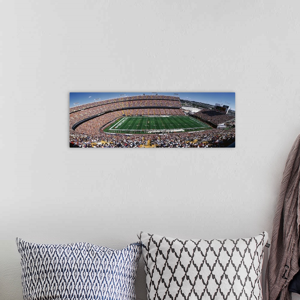 A bohemian room featuring A wide angle shot of a full Broncos stadium on a bright, sunny day.