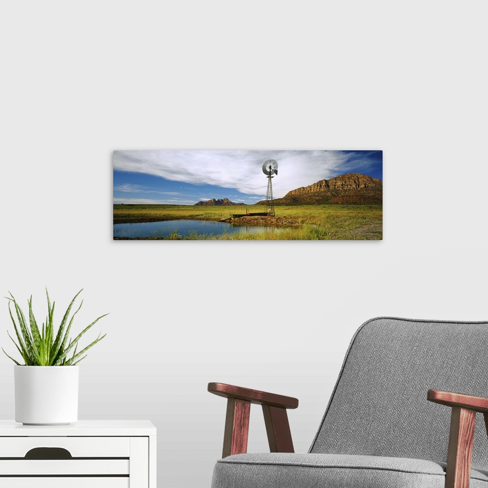 A modern room featuring Solitary windmill near a pond, U.S. Route 89, Utah