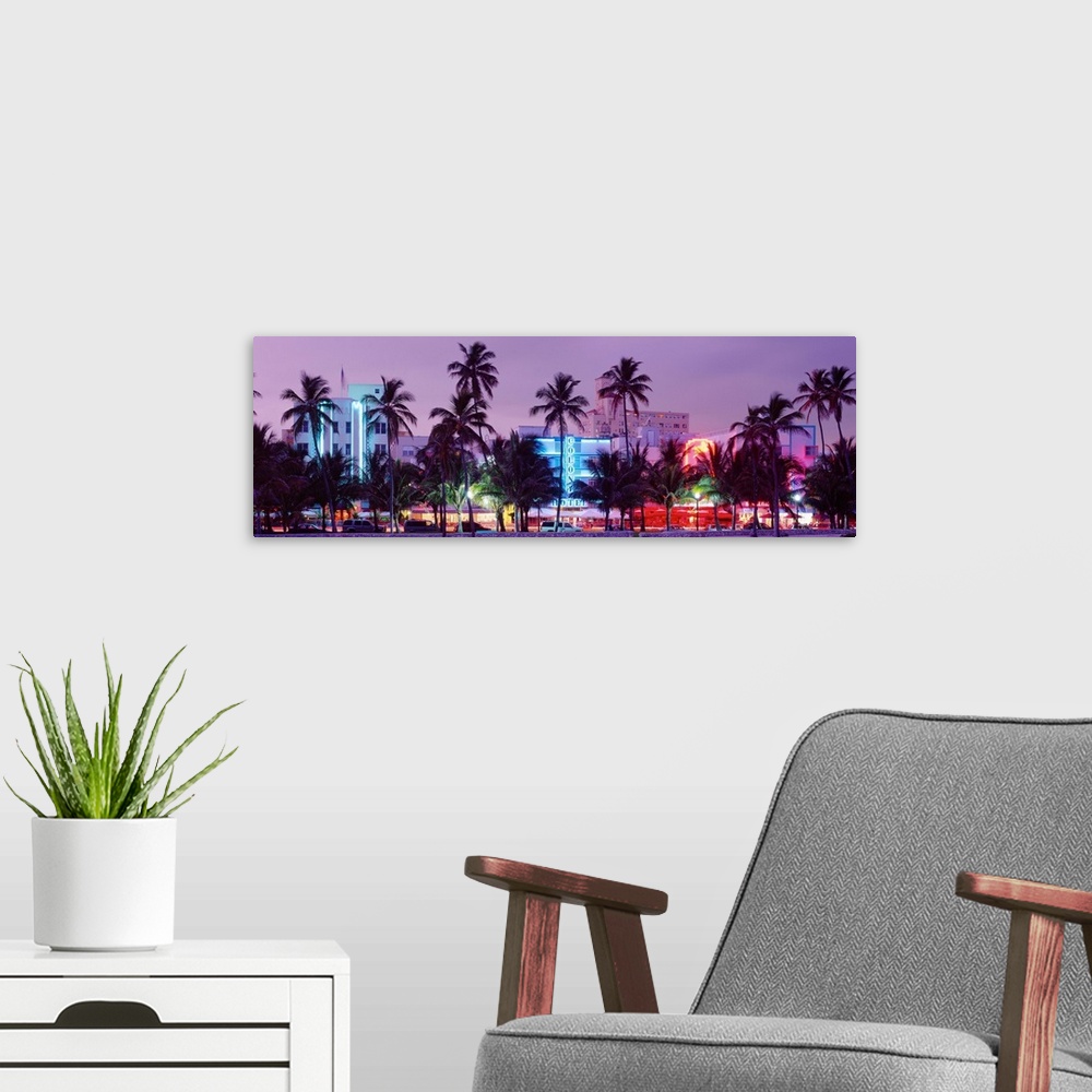 A modern room featuring View from the shore of Ocean Driveos art deco neon signs and palm trees.