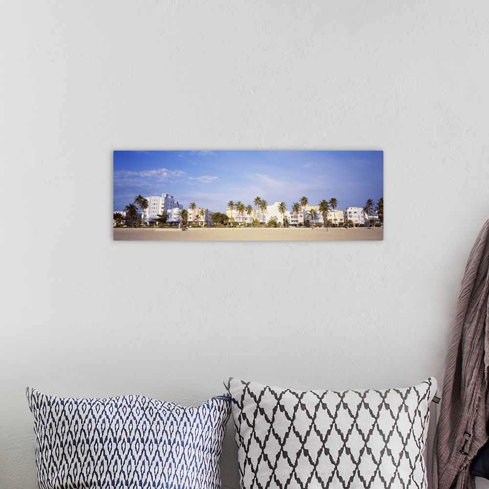 A bohemian room featuring Panoramic wall art of hotels lining a beach in Florida.