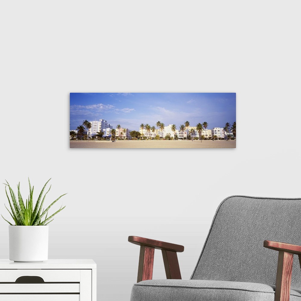 A modern room featuring Panoramic wall art of hotels lining a beach in Florida.