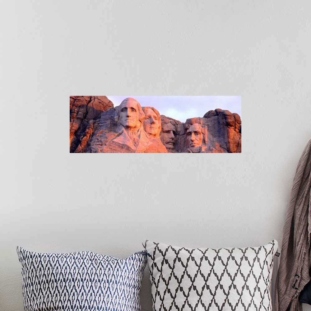 A bohemian room featuring Panorama of the world famous monument, Mount Rushmore, cast in the light of the setting sun.