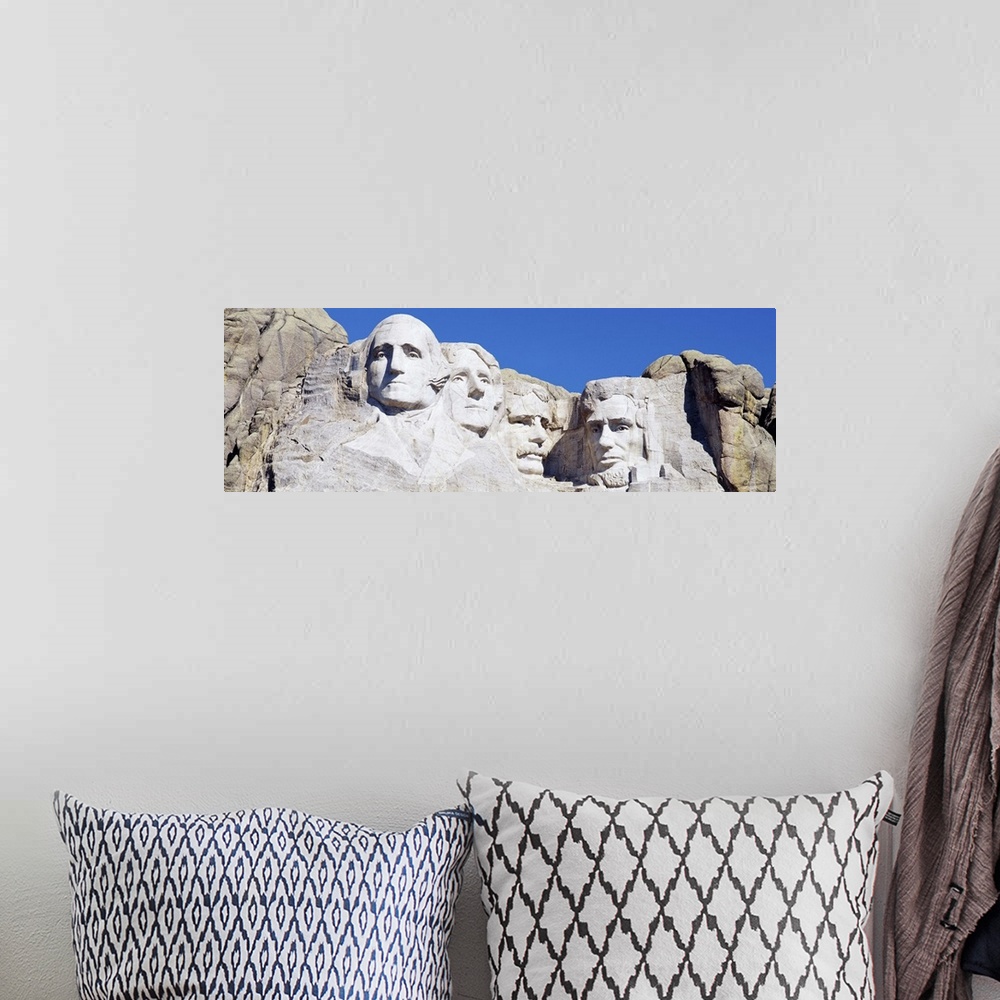 A bohemian room featuring A panorama of Mount Rushmore, a tribute meant to symbolize the first 150 years of American govern...