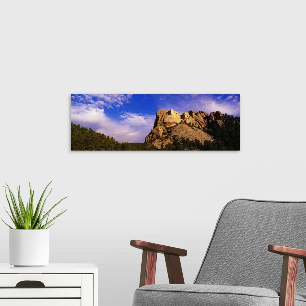 A modern room featuring A picture of Mount Rushmore is taken from a distance and has it skewed to the right in this panor...