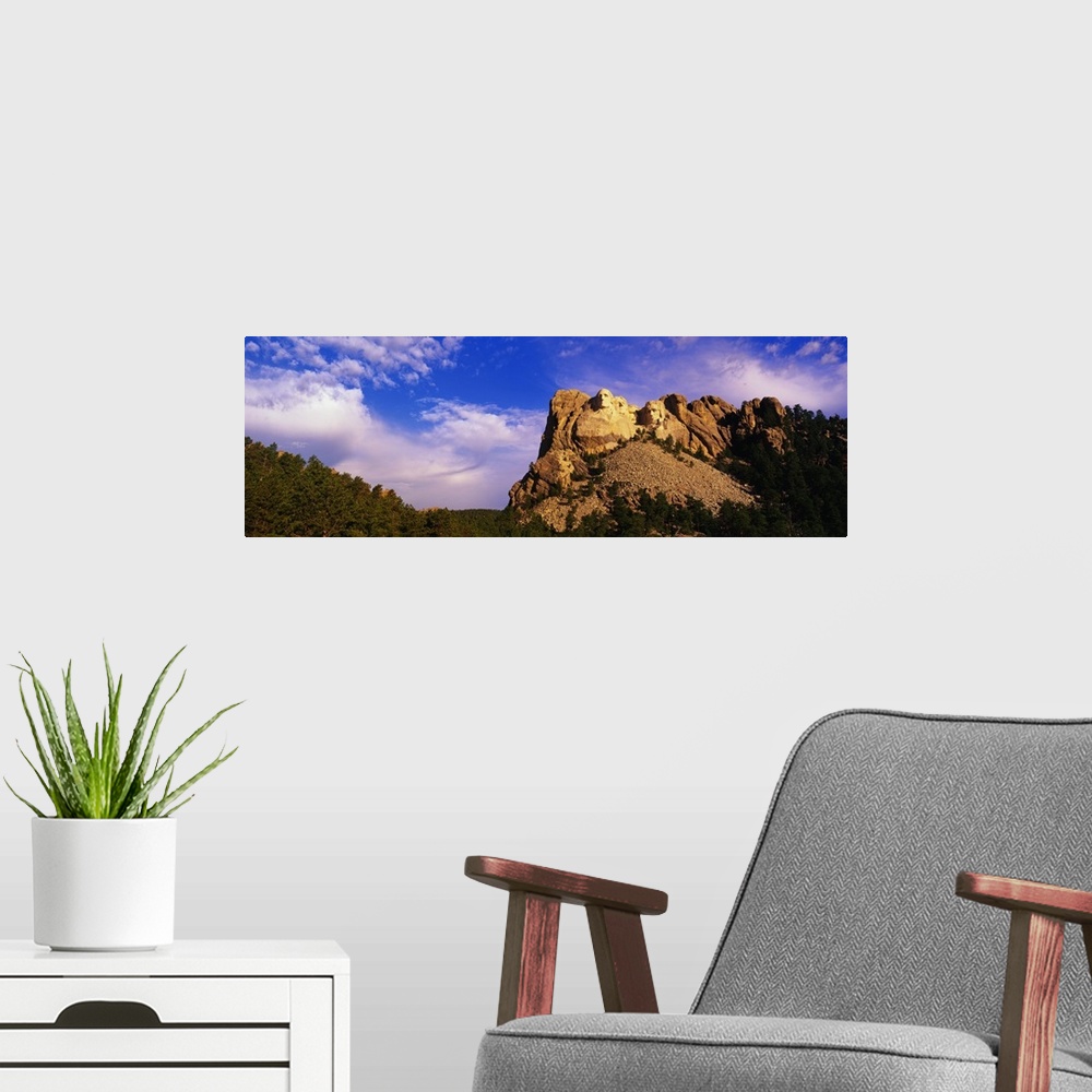 A modern room featuring A picture of Mount Rushmore is taken from a distance and has it skewed to the right in this panor...