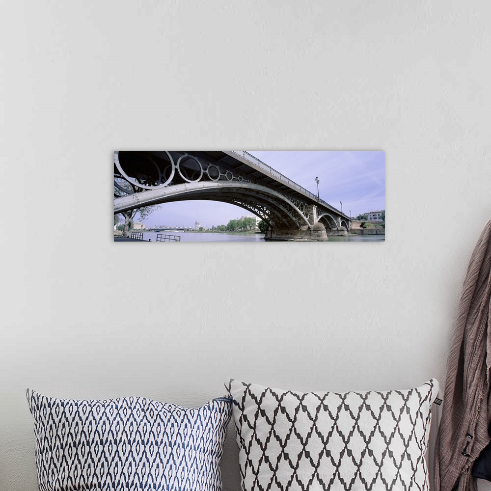 A bohemian room featuring Spain, Seville, Low angle view of Isabel II Bridge over Guadalquivir River