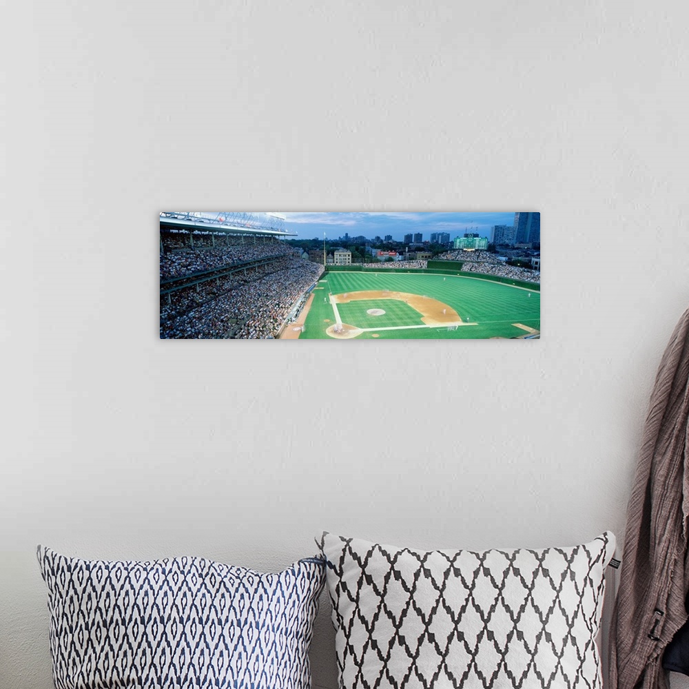 A bohemian room featuring Panoramic shot of Wrigley Field and the baseball diamond during a game as the crowd cheers.