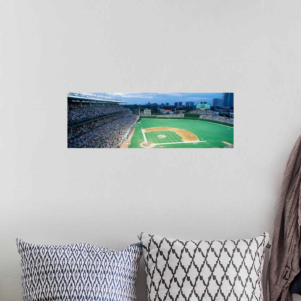 A bohemian room featuring Panoramic shot of Wrigley Field and the baseball diamond during a game as the crowd cheers.
