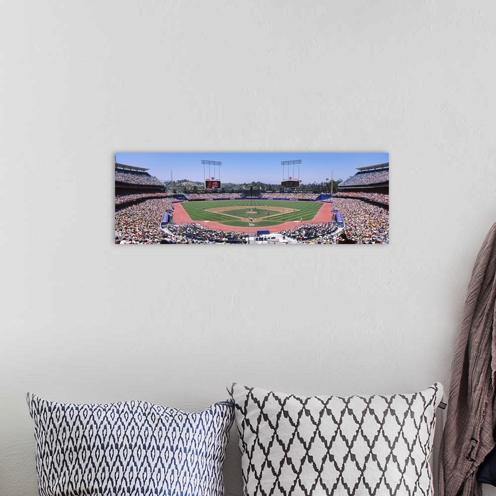 A bohemian room featuring Panoramic photograph of inside baseball stadium with game in full swing.  The stands are packed w...