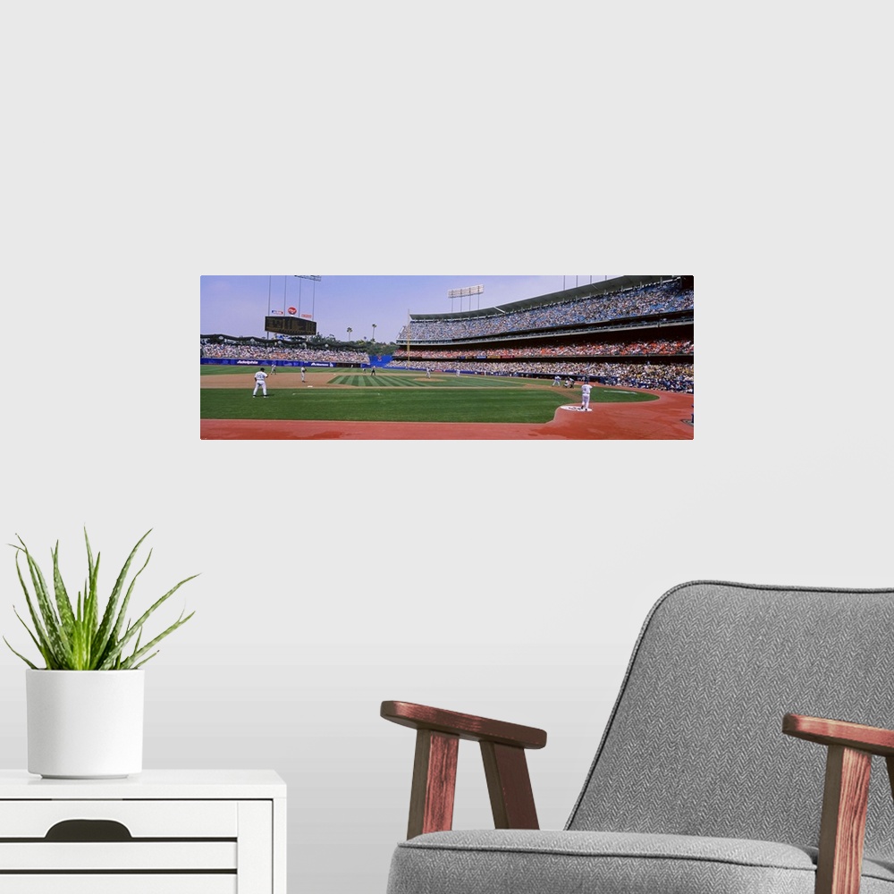 A modern room featuring A wide angle photograph taken from the third base side in Dodgers stadium as they play the Yankees.