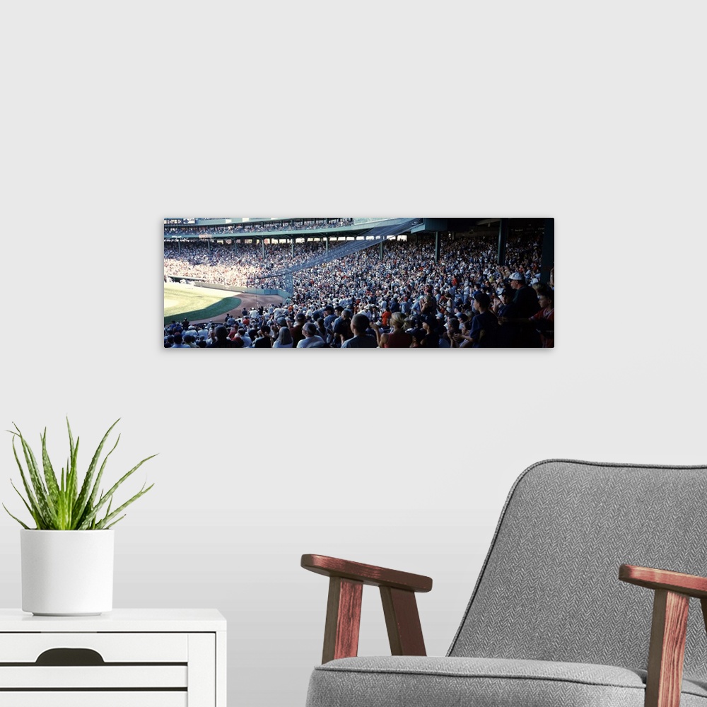 A modern room featuring Panoramic, big photograph of packed stands of fans watching a baseball game at Fenway Park, in Bo...