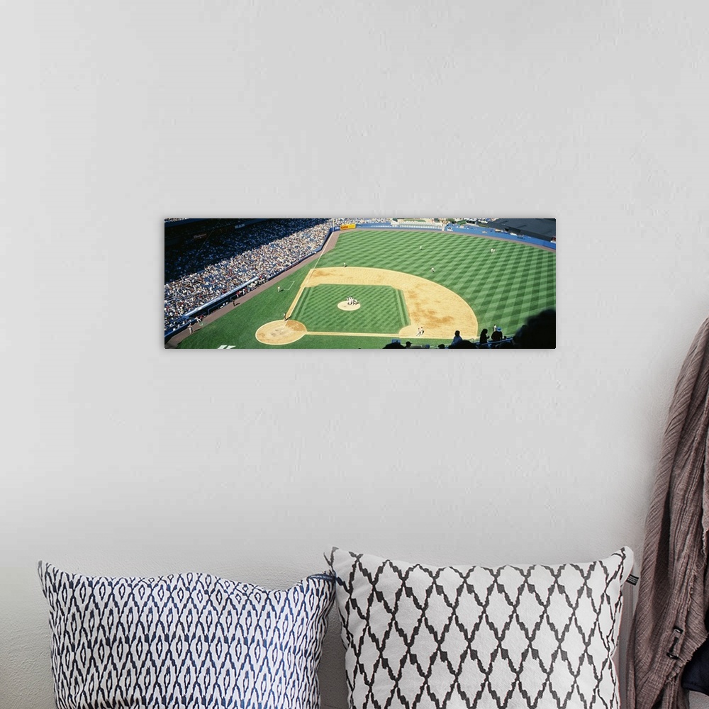 A bohemian room featuring Panoramic photograph of packed sports arena in the "Big Apple."