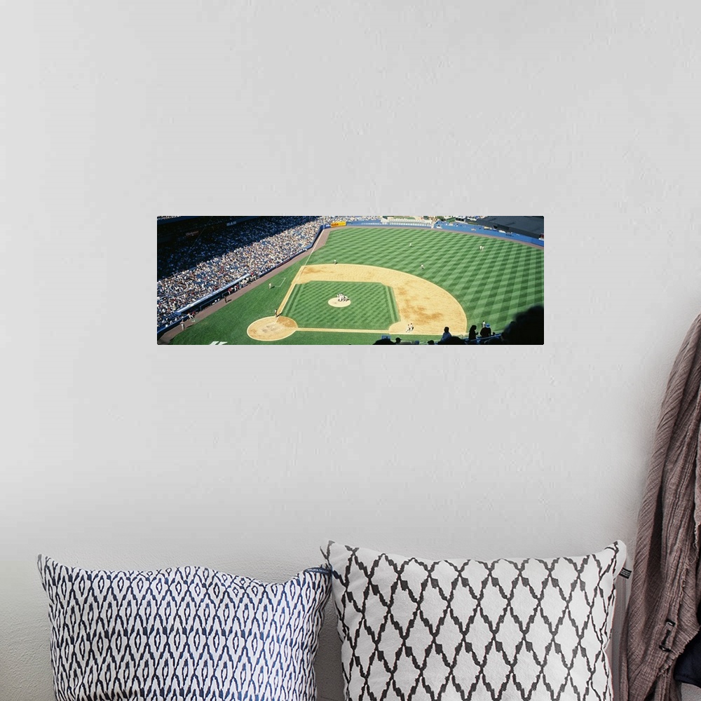 A bohemian room featuring Panoramic photograph of packed sports arena in the "Big Apple."