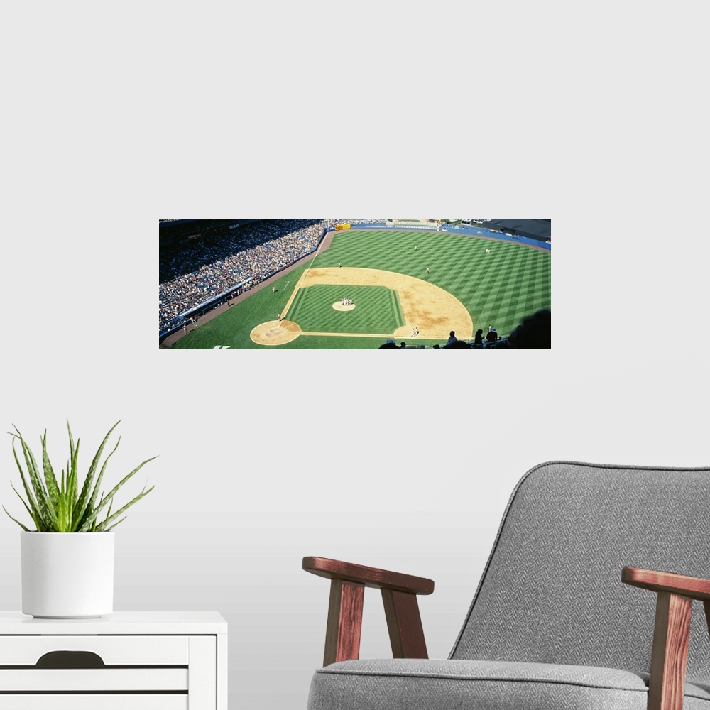 A modern room featuring Panoramic photograph of packed sports arena in the "Big Apple."