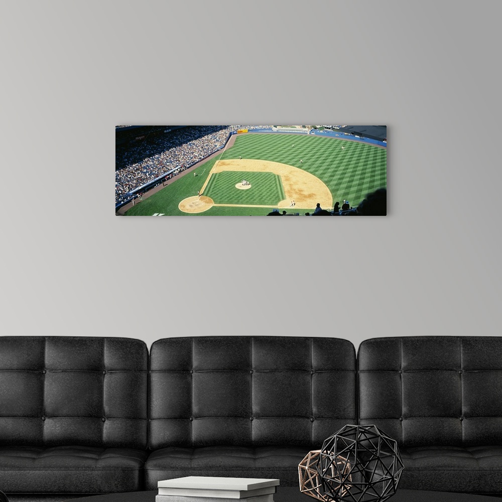 A modern room featuring Panoramic photograph of packed sports arena in the "Big Apple."