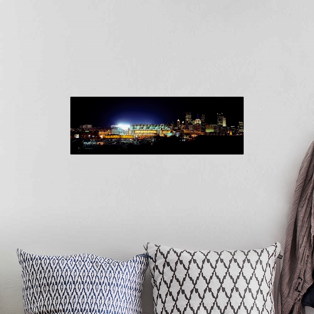A bohemian room featuring Panoramic photograph of Heinz Field lit up at night as the Steelers play a football game.  The sk...