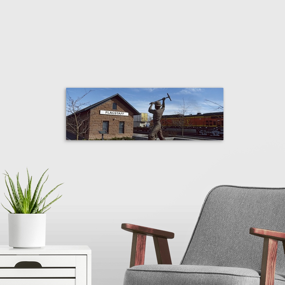 A modern room featuring Statue in front of a railroad depot, Flagstaff, Coconino County, Arizona