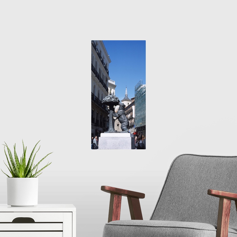 A modern room featuring Statue of a bear and a madrono tree on the street in front of buildings, Puerta Del Sol, Madrid, ...