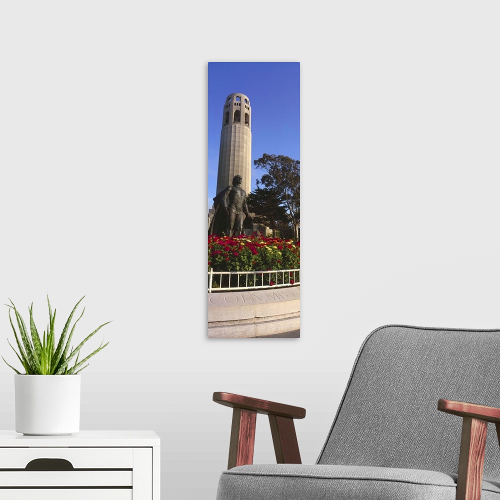 A modern room featuring Statue of Christopher Columbus in front of a tower, Coit Tower, Telegraph Hill, San Francisco, Ca...