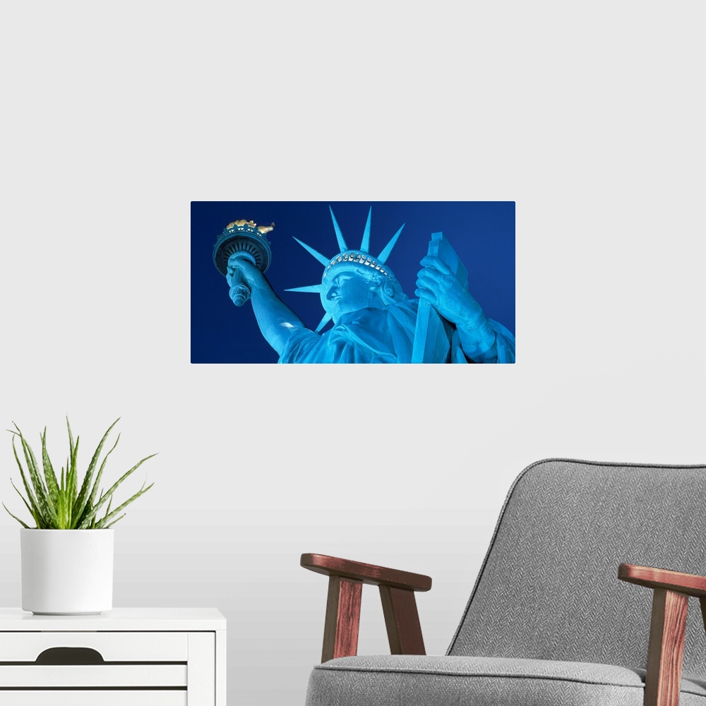 A modern room featuring View from below of the iconic American landmark against the backdrop of a starless night.
