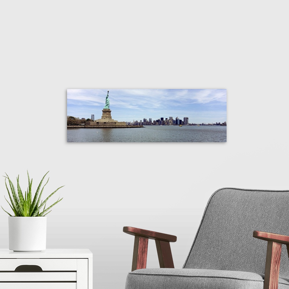 A modern room featuring Big panoramic photo on canvas of the Statue of Liberty with the NYC cityscape in the distance.