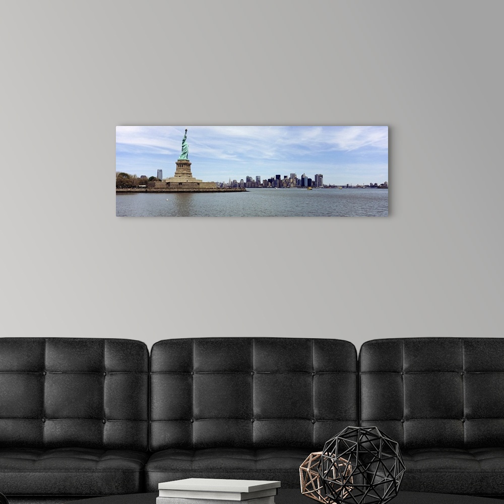 A modern room featuring Big panoramic photo on canvas of the Statue of Liberty with the NYC cityscape in the distance.